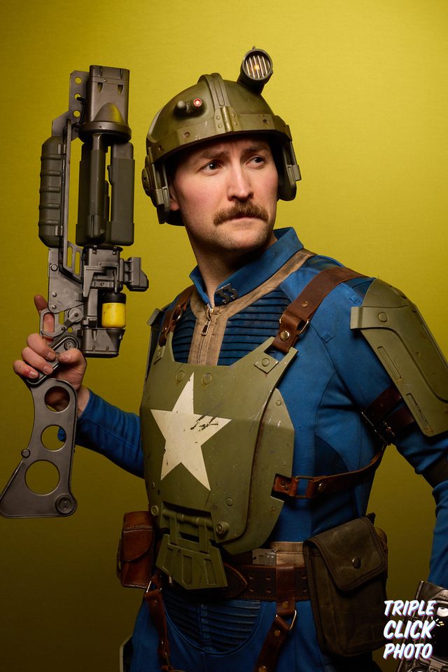 Zack in full cosplay armor and helmet, holding a prop weapon